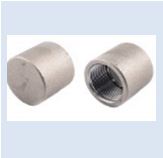 A photo of two stainless steel pipe caps, one with a threaded end and one without.